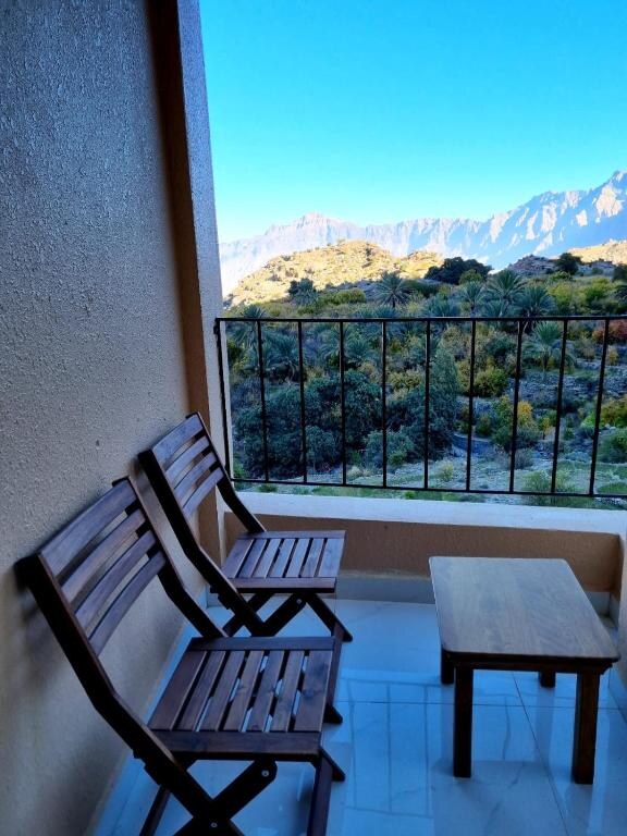 Guest room opening onto a balcony with mountain views
